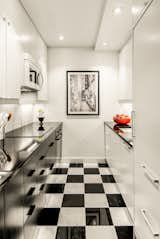 The 650-square-foot apartment has a galley kitchen with checkered black-and-white tile.&nbsp;