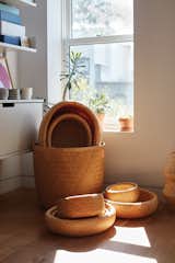 A Vitsœ shelving system and a  collection of bamboo baskets made in Vietnam occupy a sunny corner in the office that Lauren and Keith share on the top floor.