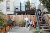 It feeds their backyard garden, which also features permeable paving rocks, a composting  bin, and a surrounding fence made  of knotty Western red cedar.