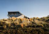 Outdoor, Shrubs, Side Yard, and Desert Michael Doherty Construction completed the 5,900-square-foot house in 2017.  Photos from Two Art World Veterans Live in This Mind-Bending Metal Home in Nevada