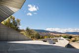 Outdoor, Desert, and Concrete Patio, Porch, Deck A concrete patio, accessible by large sliders, flows into the landscape.  Photo 4 of 19 in Two Art World Veterans Live in This Mind-Bending Metal Home in Nevada