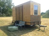 The studio took roughly three weeks to build. The wood was sourced from scraps and discarded exhibition materials from Socrates Sculpture Park and the Queens Museum. The flatbed trailer was a Craigslist find.