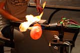 Welling then applies extra heat to keep the form of the molten glass malleable.