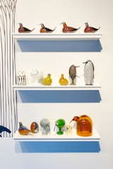 An assortment of figurines from Iittala's Birds by Toikka collection, designed by Oiva Toikka, on display at the Corning Museum of Glass.