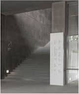 In contrast to the building's rough concrete, the environmental graphics appear in shiny, smooth materials, like this directory made of Corian.