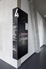University of Television and Film Munich: More detailed information is contained on distinctively designed black signs that wrap around corners almost like shadows, so that they can be easily seen from the floors and the central staircase.  Photo 3 of 49 in Way-Finding Systems by Rob Hewitt