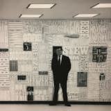 Lou Dorfsman standing infront of "Gastrotypographical". With the help of Tom Carnase, Herb Lubalin worked extensively on this typographic "wall of words" that spanned 35 feet in width and 8 feet in height. It was situated in the cafeteria at the CBS headquarters in New York City. The concept was to treat the wall like a giant typesetter's case, with a lock-up of words and objects on the theme of food. 1966