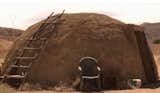 It's not all log cabins and penthouses for the Bluth family. The Bluth's showcase their resourcefulness with a number of unconventional dwellings - like this sweat-lodge constructed of mud, located near the Mexican border. The sweat lodge is tastefully furnished with plastic all weather outdoor furniture and reclaimed wood scraps.