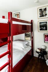 Twin-bed rooms feature bright red bunk beds for a dormitory-like experience and can be paired with adjoining rooms for larger groups of guests.
