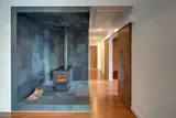 #modern #architecture #modernarchitecture #OzarkMountains #Ozarks #remote #retreat #offthegrid #minimal #LEED #interior #stove #tile #wood #DENArchitecture 