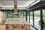A clean modern interior invites the landscape into this expansive kitchen.  Contemporary black doors marry the sleek, stylish interior with easy indoor-outdoor living.

#marvin #windows #doors #contemporary #kitchen #interior

