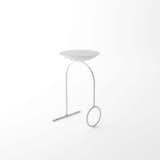 Giro is a minimal table created by Brazil-based designer Pedro Paulo-Venzon. The project serves to be multifunctional, and can be used as either a table or stool. The work is illustrated through clean lines and simple forms. The surface rests atop a curved metal frame that is composed of a circle and line that form its legs. From the side profile, the legs appear to have a simple U-shaped form. The design is available in either black or white.  Photo 4 of 4 in Tables by M D from Furniture