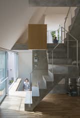 House in Tokyo is a minimal residence designed by Ako Nagao + miCo for a couple who required a music studio. The site is located between reinforced concrete mid-to-high-rise apartments and an old wooden housing area. The volume needed to be closed and "inward-looking" for the music studio space, but at the same time spread beyond the site for the couple’s livelihood.