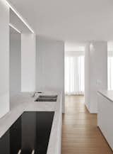 Kitchen, Undermount Sink, Light Hardwood Floor, and Cooktops  Photo 3 of 11 in 10 Minimalist and Monochromatic Homes in Belgium from De Panne by minus