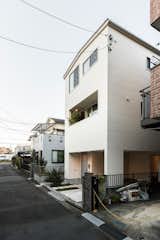 House in Hikarigaoka is a minimal residence located in Tokyo, Japan, designed by upsetters architects. The building features a covered parking space on the ground floor, a luxury that is sparse in the densely populated city of Tokyo. The staircase utilizes gaps to create transparency between the levels, and to allow natural light to fill the space. In addition, the architects placed large windows at the landing of each staircase to maximize light