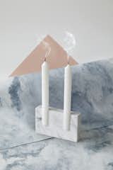Snug is a minimalist candleholder and vase created by Sweden-based designer Sanna Völker. Snug candle holder has the ability to appear rustic and embellished – or simple and neat. The candles seem to be captured in an open mould, in a loose yet sturdy embrace. The prototypes were developed by the artisan stonemason Granits Barbany, creators of sculptures for Sagrada Familia in Barcelona. Snug was later picked up by Bolia.com. Snug vase continues the formal concept used for the candle holder. The vase consists of a rectangular stone that captures a glass tube. The combination of materials give the vase an elegant and modern statement. The minimalist vase can be used with a small selection of flowers or a single leaf. Sanna Völker is an upcoming product and furniture designer who combine Scandinavian values and aesthetics with urban attitudes and contemporary lifestyles.