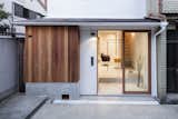 Hair Salon in Nakazaki is a minimal space located in Osaka, Japan, designed by Shimpei Oda Architect Office. Recently, many traditional houses in this neighborhood were renovated into various kinds of shops, such as cafes, restaurants, secondhand stores, and design offices. In general customers getting a haircut prefer privacy from the public. However considering the semi-private location of the salon, a glass store front was chosen. The interior floor is finished in the same texture as the material on the driveway – creating a continuous concrete surface that connects and blends the interior with the exterior.