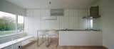 Kitchen, Granite Counter, White Cabinet, Light Hardwood Floor, Recessed Lighting, Range Hood, and Range  Photo 8 of 22 in Vida by Leibal