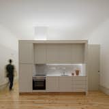Kitchen, Light Hardwood Floor, White Cabinet, Marble Counter, and Marble Backsplashe  Photos from Rua da Boavista