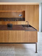 Kitchen, Wood Cabinet, Wood Counter, Wood Backsplashe, Concrete Floor, Range, and Undermount Sink  Photo 9 of 12 in Caroline Place by Leibal