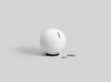 Nest is a minimalist piggy bank created by New York-based designer Lance McGregor for OTHR. This playful piece riffs on the iconic shape of the piggy bank, as seen through a minimalist lens. Distilled down to a single orb, Nest rest on a steel base that doubles as a hammer to shatter its porcelain exterior. “I love the idea of ‘breaking the piggy bank’ to see what rewards lie within,” says McGregor. “As a kid, it was always exciting to see how much I’d been able to save.” Nest neatly embodies the paradox of “no reward without sacrifice;” once filled, the object must be forgone to reap the benefits inside. As an added, unexpected whimsy, a 3D printed nylon pig lives within Nest’s sphere—an homage to the object’s forbearers.