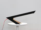 Blackbird Lamp is a minimalist light created by Berlin-based designer Hayo Gebauer. The Blackbird Lamp features an edged design that balances its craning light on two feet. It’s simply constructed from a single sheet of steel. The LED light source incorporates a motion sensor which functions as the on/off switch. By waving ones hand under the shade you activate the light. Holding ones hand for a couple of seconds activates the dimming mode on the lamp, allowing for a smoother, more nuanced setting.  Photo 1 of 188 in Products by Leibal