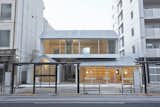 Ajiroen is a minimal architecture project located in Tokyo, Japan, designed by TYRANT. The purpose of this project was to renovate and open up five buildings owned by Ajiroen, a long-established retail shop specialized in Japanese tea in Yokoyama-cho, Hachioji City, to local people as a commercial and cultural facility. Located seven or eight minutes by foot from the north gate of JR Hachioji Station, the rectangular plot is sandwiched between Koshu Kaido Avenue and a public walk on the north and south sides. On this plot five buildings stand close together: two storehouses (kura) built in the late 19th century to early 20th century, a Japanese-style house and a shop built immediately after World War II, and a reinforced concrete building built in the late 1960s to the early 1970s. As part of this project, a small town block was created as a conglomeration of the history of Hachioji and the consolidated elements of the community by rebuilding the shop, renovating the four other buildings, laying a garden path (roji) north and south through the elongated plot, and making a small open space garden (niwa) facing the public walk.