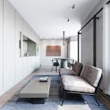 56 sqm Apartment is a minimal space located in Minsk, Belarus, designed by Lera Brumina. The space is characterized by a narrow length with an open floor plan. The kitchen and storage are placed along a wall and feature custom built-ins in order to maximize space. A custom headboard constructed of walnut fills the width of the bedroom. Walnut is also expressed and accented in the living and bathroom space as storage panels.