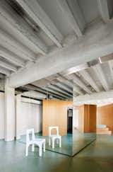 700m2 Apartment is a minimal renovation located in Spain, designed by ARQUITECTURA-G. The first time the architects visited the space with its new owner, the sewing machines and the rolls of fabric were still in place. It was a single diaphanous space of approximately 10 × 70 meters intended for a tailoring shop that had closed its doors. The assignment consisted of transforming the workshop into a single-person home. In addition to the usual requirements of a home, the programs would include a study area and an artistic creation workshop.