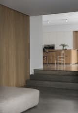 The Gjøvik House is a minimal residence located in Oslo, Norway, designed by Norm Architects. An hour north of Oslo, located on a majestic hill side facing the Norwegian woods and Mjøsa lake, lies the Gjøvik house; a modern and minimal cluster house created by Norm Architects. The Gjøvik house, consisting of overlapping cubes of different sizes, makes for an intimate and dynamic family home with materials, levels and inbuilt, tailor-made furniture creating a minimal yet warm and secluded feeling. The house gracefully embraces the hill side terrain, merging with its surroundings in a humble and natural manner. Having thoroughly considered the climate in the process of designing the house, the idea behind the cluster style house was to give the home a cosy and inviting feel, where you can truly hibernate while taking shelter from the frigid days of Nordic winter.
