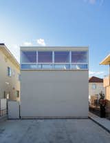 House K is a minimal residence located in Maebashi, Japan, designed by Shinta Hamada Architects. House K is sited in the suburbs of Maebashi city in Japan. There are many similar houses around the site which create a consistent landscape. The architects tried to make small changes by creating a new context within a limited site area. The designers designated the rooms as either common spaces or private spaces. They placed the private spaces on the north side of the volume and common spaces on the south side where the surrounding is open. In addition, to connect two different spaces, there are “free spaces” arrange in between.