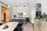 Apartamentai Vilniaus is a minimalist apartment located in Vilnius, Lithuania, designed by Kristina Lastauskaitė-Pundė. The apartment is characterized by brass volumes that form a portion of the walls and ceiling as well as some of the fittings. Herringbone floors mixed with the structure’s original moldings and archways maintain its classic look while the rest of the space is contrasted with modern accents. The furnishing follows this principle of contrast by mixing classics with modern styles.