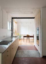 Conversion in Brugg-Windisch is a minimalist renovation located in Windisch, Switzerland, designed by Wülser Bechtel Architekten. The original 1930s structure was two small flats, which were combined to create the family home. There was an overall subtraction of components and structural elements while adding space-defining fixtures and wood paneling. It was a peculiar balance between careful demolition and uncompromising preservation. By consciously refraining from unifying measures, the original elements of the house remain atmospherically intact without becoming decoration. On the ground floor and in the attic, new structural openings sharpen the atmospheric and functional significance of finely balanced, doorless transitions.