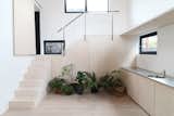 Tatami Home is a minimalist floating house located in Amsterdam, The Netherlands, designed by Julius Taminiau Architecten. The home is characterized by built-in storage and furniture in order to maximize the small space interior. The architect was inspired by traditional tatami rooms from Japan in order to guide the proportions of the internal layout. Tatami mats have similar proportions to plywood panels, which were used abundantly throughout the space. An open staircase serves as a partition separating the the living area from the dining room and kitchen.