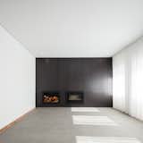 Sao Francisco House is a minimalist residence located in Guarda, Portugal, designed by Filipe Pina. The project is an urban typical house of the first half of the 20th century, presenting three sides and a garden. The surrounding buildings are characterized by several types of construction, a consequence of the successive city urbanistic growth stages. The clients wanted a pragmatic solution to the project, “willing to renew and rehabilitate the house with minimum demolition and in the most economical way”. The optimal conditions and building characteristics of the house allowed for a good project development. Soon, the designers understood that the living spaces of the house needed to be simplified, as it did show some old-fashioned elements added over time by the different owners, with external parts losing their coherence and some gloomy interiors agglomerated in quite messy, obsolete and isolated rooms. They kept the original functional layout of the house, where we only inserted few changes in view of adapting it to actual modern requirements, namely for the kitchen, toilets and bathrooms, and very seldom demolitions which allowed new internal paths. It was also decided to keep the original floors, wooden structures, some the roof and surfaces. Now the house lives from its inside where all spaces merge into one unique light and bright room.