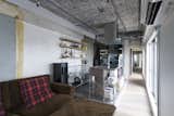 House in Daikanyama is a minimalist apartment located in Tokyo, Japan, designed by Roovice. The renovation sought to maintain a stripped down industrial aesthetic, leaving the ceiling and concrete walls exposed. The kitchen is slightly elevated and features a stainless steel countertop with a steel rangehood. The bedroom is detached from the kitchen and living area in order to maintain privacy.
