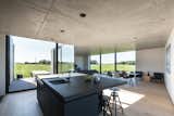 Dining, Chair, Bar, Stools, Light Hardwood, Table, and Recessed  Dining Table Recessed Stools Light Hardwood Chair Bar Photos from Defying traditionalism: concrete bungalow inserted in a rural Belgian landscape