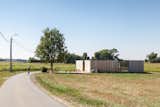 Outdoor, Field, Front Yard, Walkways, Grass, and Trees  Photo 2 of 14 in Defying traditionalism: concrete bungalow inserted in a rural Belgian landscape