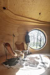 Living Room, Chair, Ceiling Lighting, Medium Hardwood Floor, and Rug Floor  Photo 1 of 38 in This Beguiling Guesthouse in Belgium Has an Underground Cinema and a Watchtower from Alex' Guesthouse by Atelier Vens Vanbelle