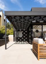 A steel-and-redwood fabrication makes up the diamond shape of the trellis.&nbsp;