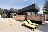 The wraparound porch leads to a sunken backyard with a pool and outdoor shower where the kids can rinse off their surfboards.