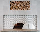 The six-foot wood-burning oven features the same sunburst tile as the floors.&nbsp;