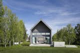 Outdoor, Back Yard, Grass, Shrubs, Small Patio, Porch, Deck, and Trees  Photo 11 of 12 in This Modern Farmhouse Outside Toronto Makes Its Own Rules