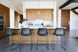 The industrial bar stools in the minimalist kitchen were purchased at ABC Home.&nbsp;