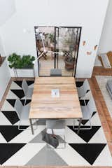 Dining Room, Ceramic Tile Floor, Table, Chair, Rug Floor, Pendant Lighting, and Medium Hardwood Floor Geometric patterns were a big part of the home's design, and that's best showcased by the dining room's  Photos from A Venice Beach Abode Becomes a Chic Co-Living Space Where Everything's For Sale
