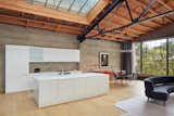 Kitchen, Drop In, White, Range, Refrigerator, Pendant, Rug, Wall Oven, Track, and Light Hardwood This loft was once a knitting mill in San Francisco.  Kitchen Track Range White Photos from Top 10 Cities to Witness Stunning Architecture Across America