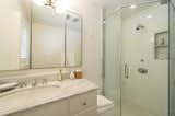 Bath Room, Enclosed Shower, Marble Counter, Undermount Sink, and Wall Lighting The home's sole bathroom features a marble countertop.  Photo 6 of 9 in Here's Your Chance to Stay in the Vacation Home Marilyn Monroe Used to Rent