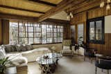 Living Room, Sectional, Bench, Chair, Pendant Lighting, Rug Floor, Coffee Tables, and Medium Hardwood Floor Original wood features mix with airy daybeds at the front of the property.  Photos from A 1940s Beach Home Is Restored Into a Gorgeous Clubhouse in L.A.