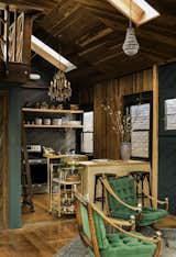 Kitchen, Wood Counter, Pendant Lighting, Medium Hardwood Floor, Open Cabinet, Wood Cabinet, and Range The full kitchen was meant to incorporate Old Hollywood glamour and the look of a Parisian café.  Photos from A 1940s Beach Home Is Restored Into a Gorgeous Clubhouse in L.A.