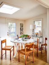 Dining, Table, Chair, Light Hardwood, Shelves, Table, and Lamps Coworkers can get things done at this "dining area,  Dining Chair Lamps Table Table Shelves Photos from ASH’s Homey New Office in the Hamptons Inspires Creativity